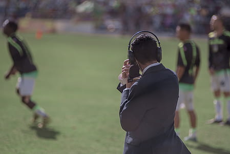 man wearing black headphones and black suit jacket thumbnail