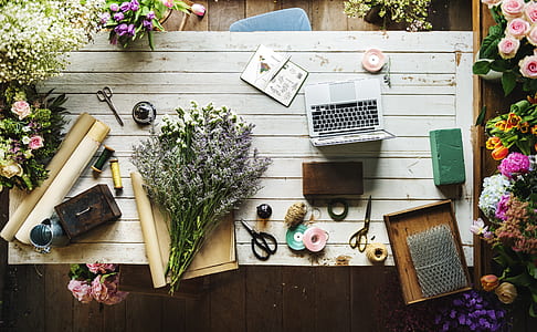 flowers on brown paper and near laptop thumbnail