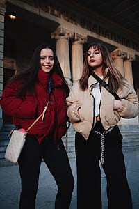 two women standing to each other thumbnail