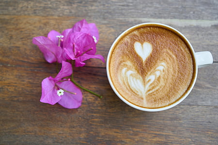 white ceramic coffee mug beside pink flowers thumbnail