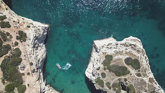 green body of water under sunny sky thumbnail