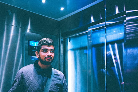man standing inside elevator thumbnail