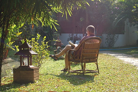 man sitting on armchair in garden during daytime thumbnail