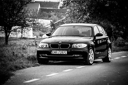 BMW 1-series 5-door hatchback on road near trees and houses at daytime thumbnail