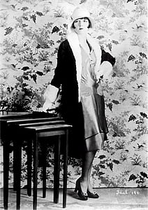 woman standing and leaning on table thumbnail