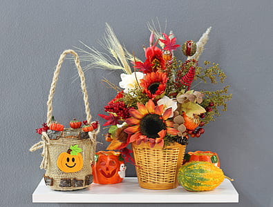 flowers on brown woven basket beside papaya and bucket thumbnail