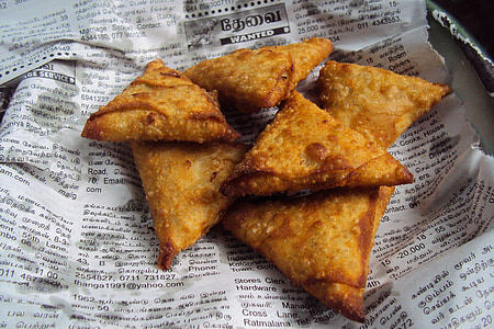 fried pastries on newspaper thumbnail