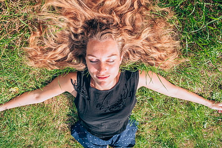 woman lying on green grass thumbnail