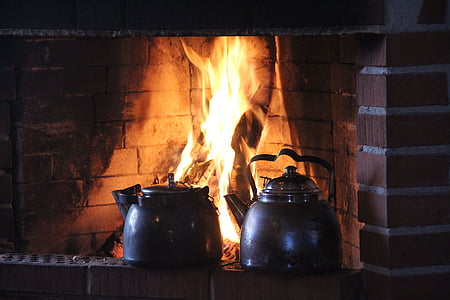 two gray kettles on brown fireplace thumbnail