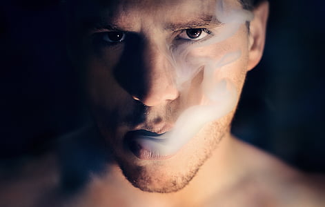 photo of man blowing smoke thumbnail
