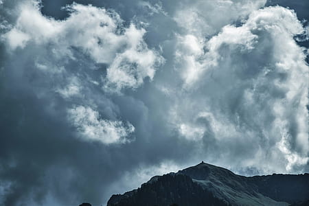 snow covered mountain under gray sky during daytime thumbnail