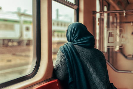 woman sitting near train window taken at daytime thumbnail