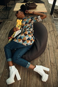 Woman Wearing Multicolored Dress Holding on Gray Bean Bag thumbnail