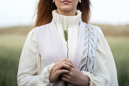 woman holding grass in white top thumbnail