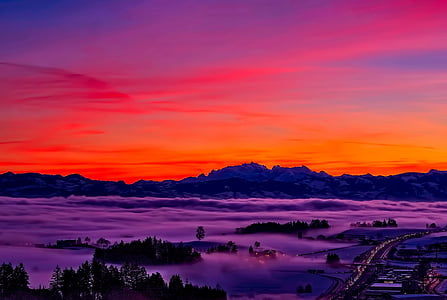 silhouette of mountain during golden hour across road and fog-covered isles illustration thumbnail