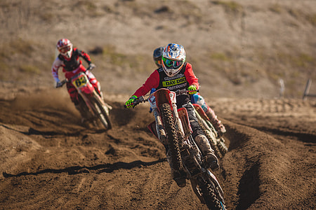 three person riding motocross dirt bike on tracks thumbnail