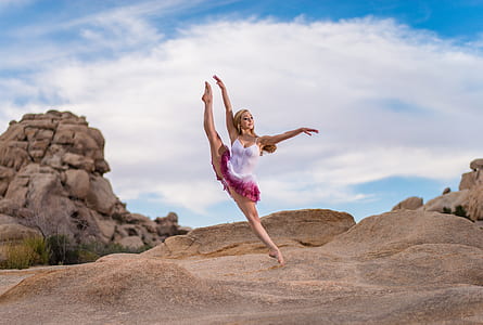 woman wearing white and pink dress dancing ballet on sand thumbnail