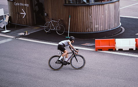 person riding bicycle on asphalt road thumbnail