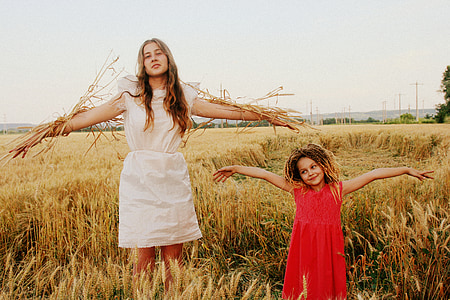 woman and girl standing in field of ferns thumbnail