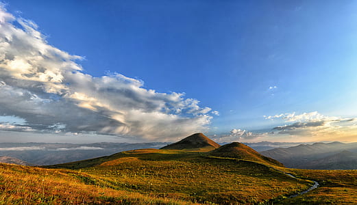 photo of mountain under blue sky thumbnail