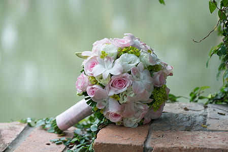 white and pink flower bouquet on brown paver brick thumbnail