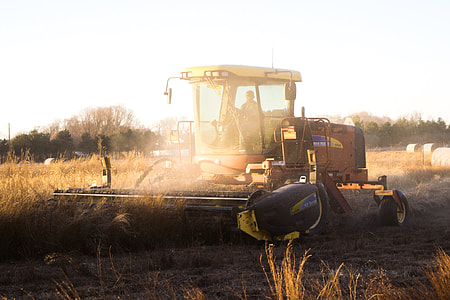 selective focus photography of yellow harvester on field thumbnail