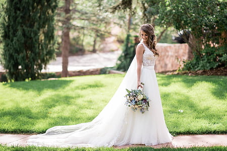 woman wearing wedding gown and holding flower bouquet thumbnail