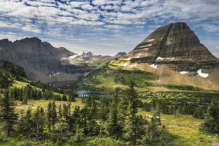 mountain near river under partially cloudy skies thumbnail