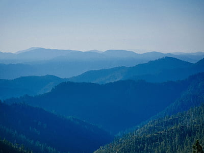 mountains surrounded by green leaf trees thumbnail