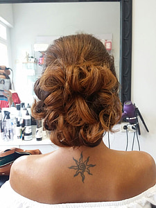 closeup photo of woman wearing white off-shoulder top with black sun tattoo in back thumbnail