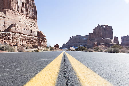 asphalt road near rock formation thumbnail