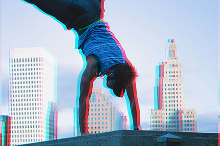 man hand stand on concrete with high rise building in distance thumbnail
