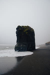 brown rock formation on seashore thumbnail