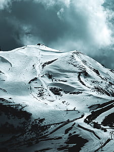 mountain covered by snows under gray clouds thumbnail