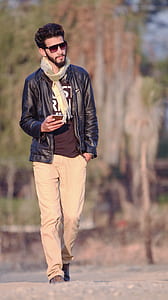 man walking while holding phone thumbnail