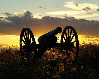 sihouette of antique cannon during sunset thumbnail