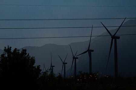 silhouette of windmills at daytime thumbnail