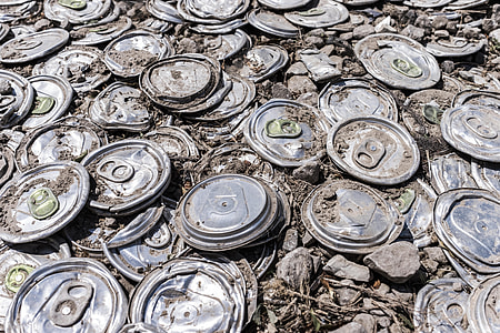 grey flat soda cans with rocks during daytime thumbnail