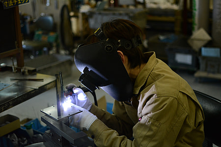 man in gray long-sleeve shirt wearing welding mask thumbnail
