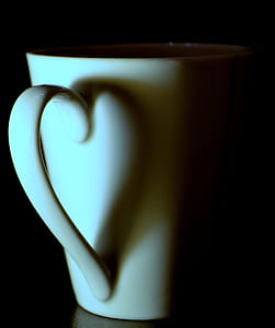 white ceramic teacup on black surface thumbnail