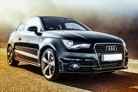 black Audi coupe with black smoke background at daytime thumbnail