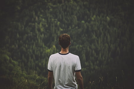 selective focus photography of man wearing white crew-neck t-shirt thumbnail