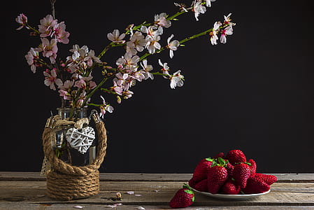 strawberries on plate beside pink flowers thumbnail