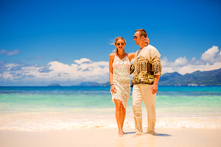 man and woman standing on seashore thumbnail