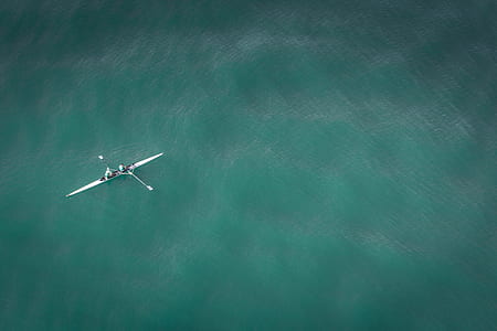 aerial photography of white boat in middle of body of water thumbnail