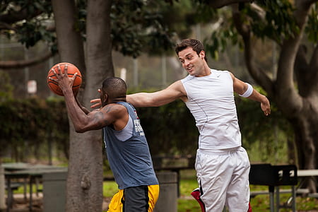 man blocking man's face holding basketball thumbnail