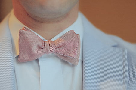 man with grey suit jacket and red bowtie thumbnail