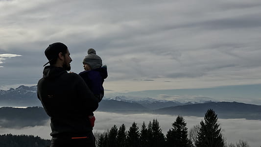 Man Holding a Baby Photo thumbnail