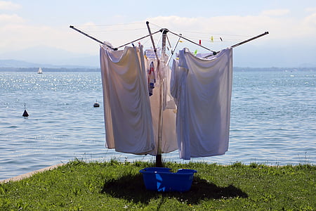 white apparels hanging beside body of water thumbnail