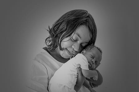 grayscale photo of woman carrying baby thumbnail